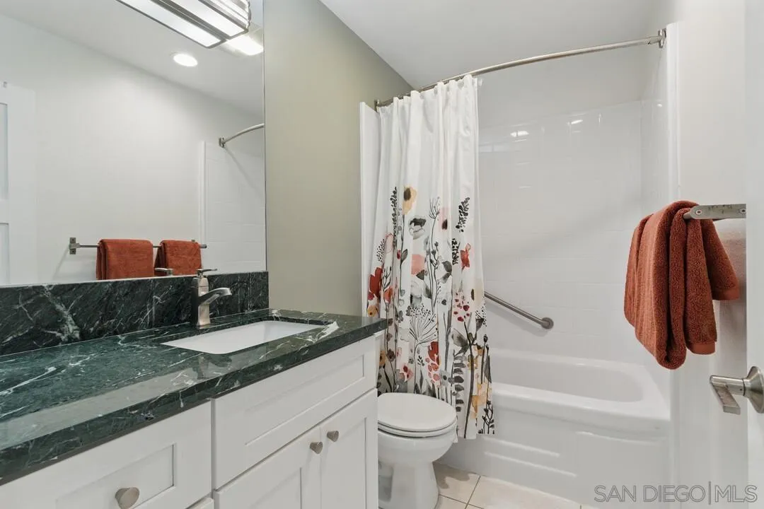 8536 Via Mallorca, Unit B La Jolla, CA 92037 - Photo 18 of 34 a bathroom with a sink a toilet and a shower