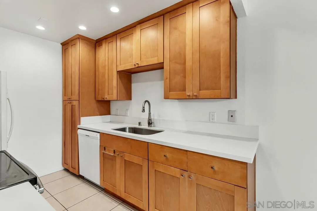 8536 Via Mallorca, Unit B La Jolla, CA 92037 - Photo 6 of 34 a kitchen with stainless steel appliances granite countertop a sink and a cabinets