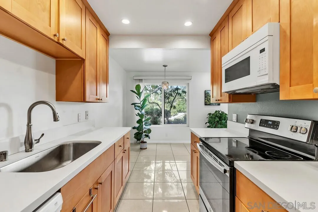 8536 Via Mallorca, Unit B La Jolla, CA 92037 - Photo 7 of 34 a kitchen with a sink cabinets and a stove
