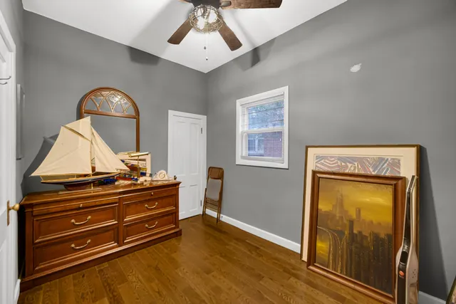 a room with a dresser and chandelier