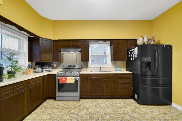 a kitchen with a refrigerator and a sink