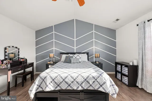 a bed sitting in a bedroom next to a window