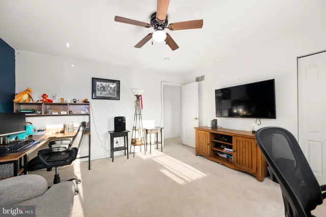 a view of a livingroom with furniture and a flat screen tv