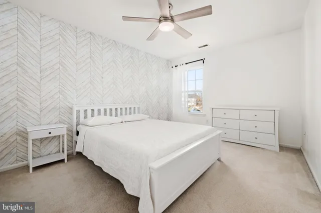a bedroom with a bed and a baby crib