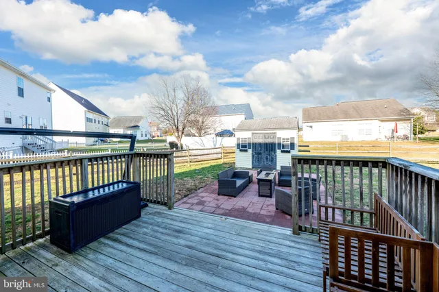 a view of a patio with couches chairs and a yard