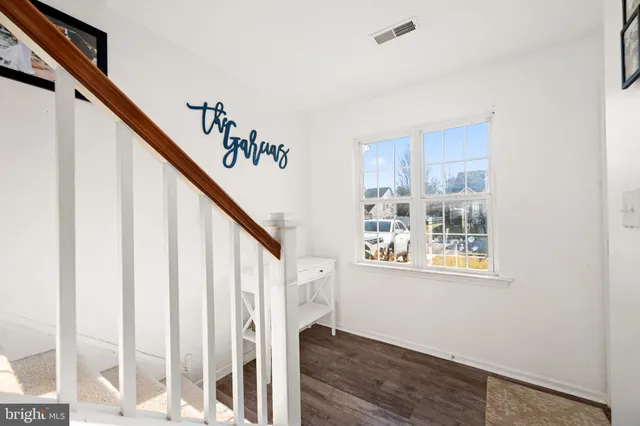 a view of entryway with stairs and wooden floor