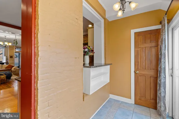 a view of hallway with closet and wooden floor