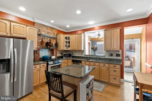 a kitchen with stainless steel appliances granite countertop a refrigerator stove and oven