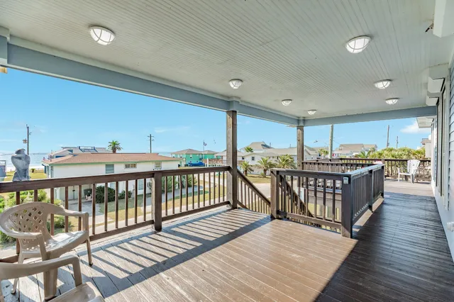 a view of a deck with wooden floor and outdoor seating