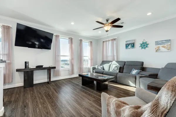 a living room with furniture and kitchen view