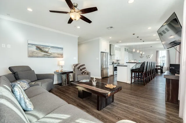 a kitchen with stainless steel appliances kitchen island granite countertop a table chairs sink and cabinets