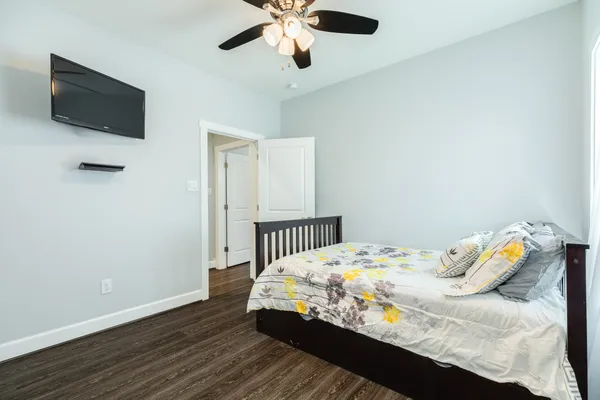 a bedroom with a bed and a chandelier