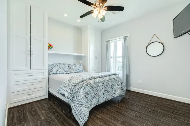 a bedroom with a bed table and a window