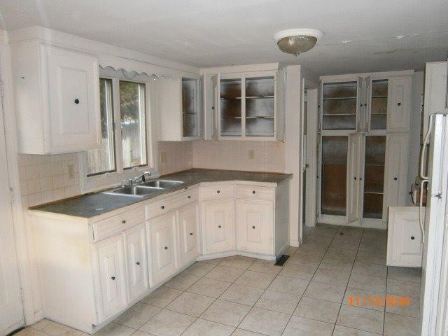 149 Seabrook Road, Unit 1 & 2 Hyannis, MA 02601 - Photo 12 of 16 a kitchen with granite countertop a sink and cabinets