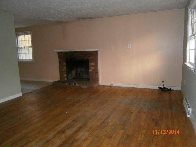 149 Seabrook Road, Unit 1 & 2 Hyannis, MA 02601 - Photo 14 of 16 an empty room with wooden floor and windows