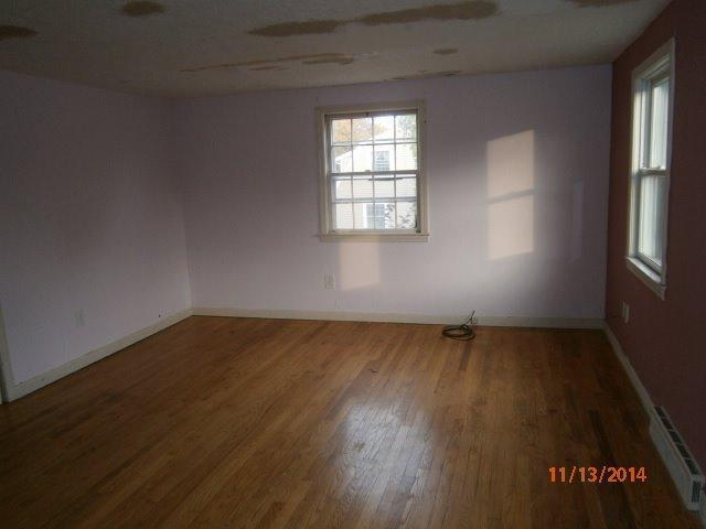 149 Seabrook Road, Unit 1 & 2 Hyannis, MA 02601 - Photo 15 of 16 an empty room with wooden floor and windows