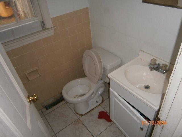 149 Seabrook Road, Unit 1 & 2 Hyannis, MA 02601 - Photo 5 of 16 a bathroom with a toilet sink and mirror