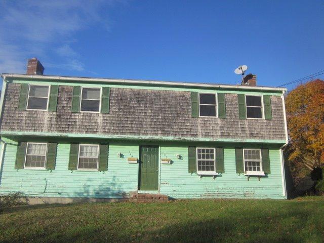 149 Seabrook Road, Unit 1 & 2 Hyannis, MA 02601 - Photo 6 of 16 a front view of a house with a yard