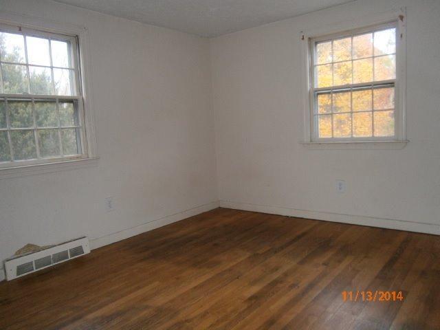 149 Seabrook Road, Unit 1 & 2 Hyannis, MA 02601 - Photo 7 of 16 an empty room with wooden floor and windows