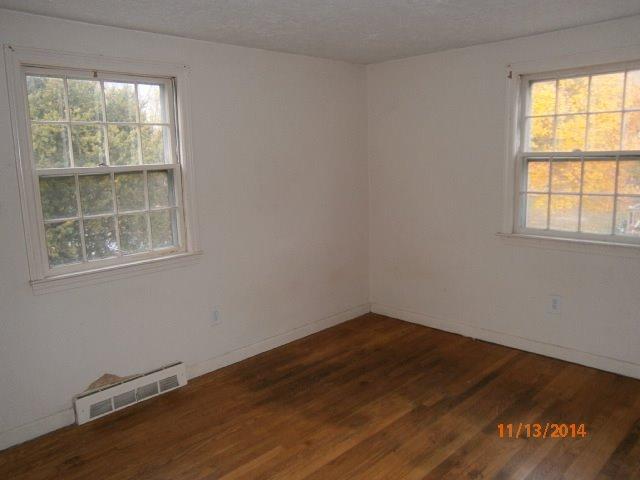 149 Seabrook Road, Unit 1 & 2 Hyannis, MA 02601 - Photo 8 of 16 an empty room with wooden floor and windows