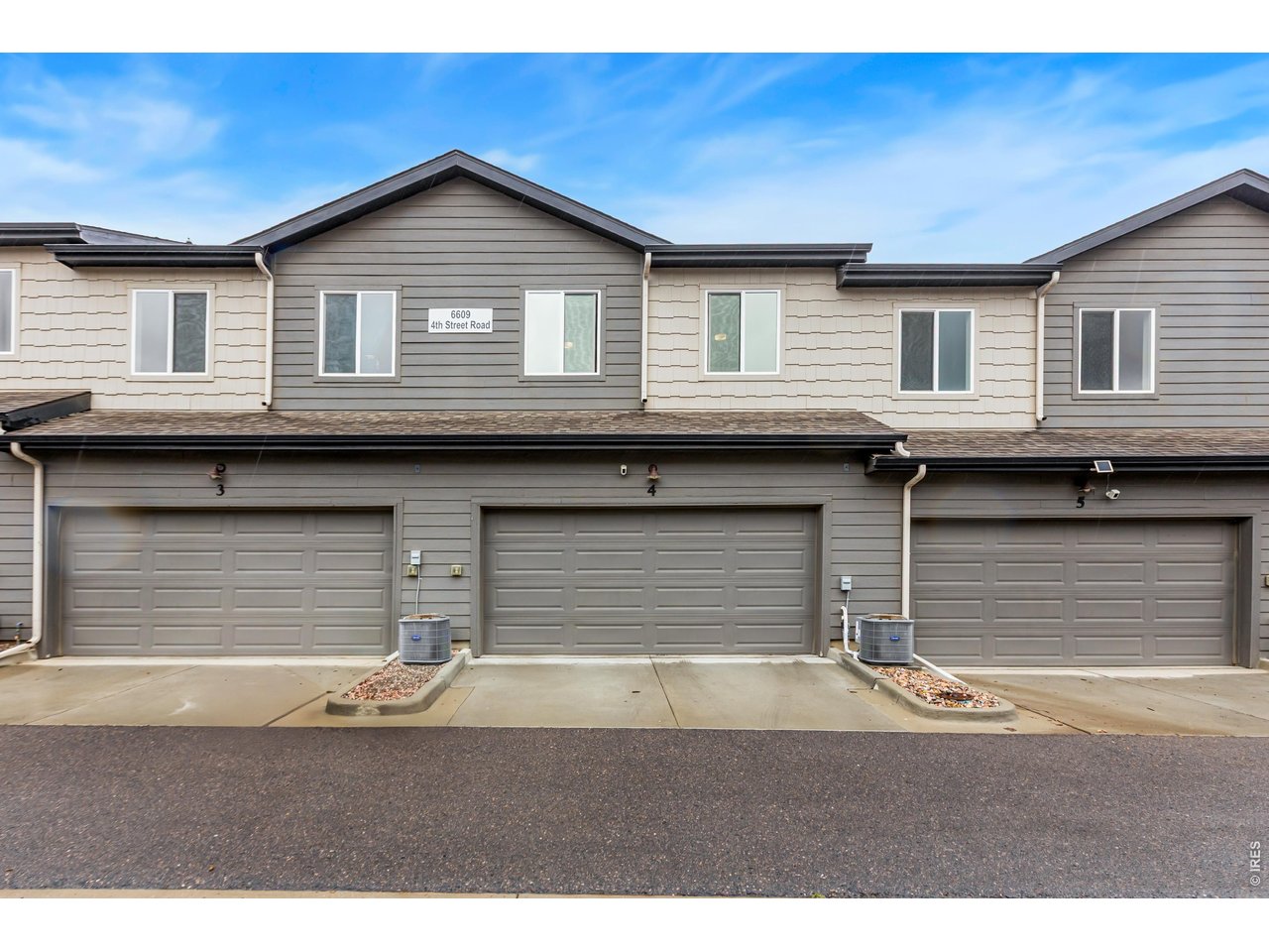 6609 4th St Road, Unit 4 Greeley, CO 80634 - Photo 38 of 41 a front view of a house with a garage