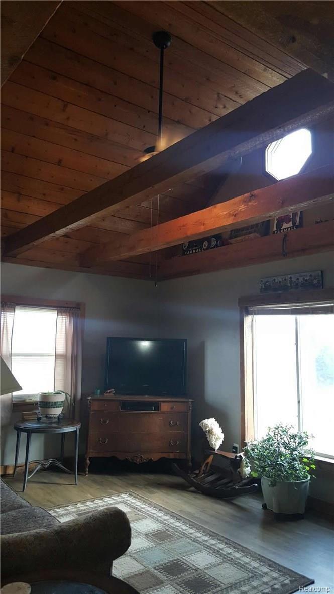10140 Chase Lake Road Fowlerville, MI 48836 - Photo 13 of 22 Living Room with planked cathedral ceiling and beams