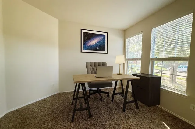 a view of a dining room with a table and chairs