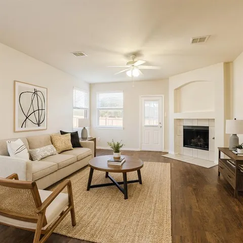 a living room with furniture and a fireplace