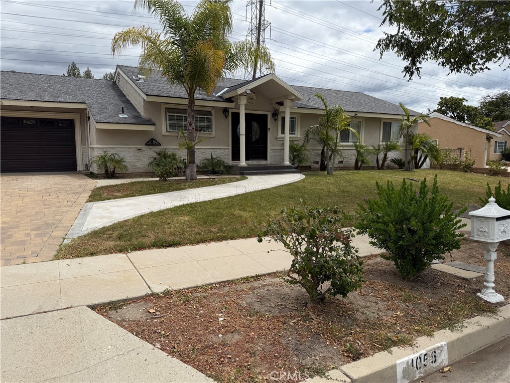 11056 Chimineas Avenue Porter Ranch, CA 91326 - Photo 1 of 3 a front view of a house with garden