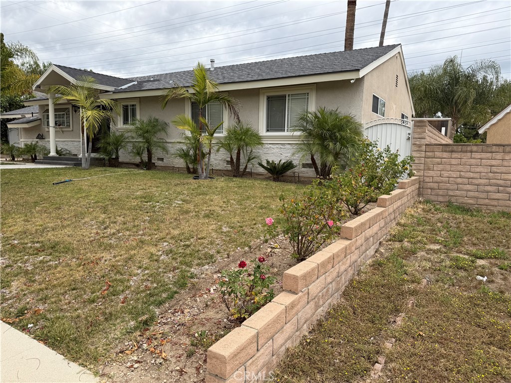 11056 Chimineas Avenue Porter Ranch, CA 91326 - Photo 2 of 3 a front view of a house with garden