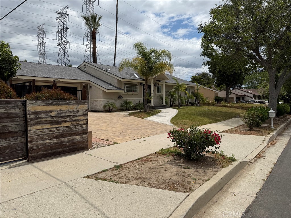11056 Chimineas Avenue Porter Ranch, CA 91326 - Photo 3 of 3 a front view of a house with a yard