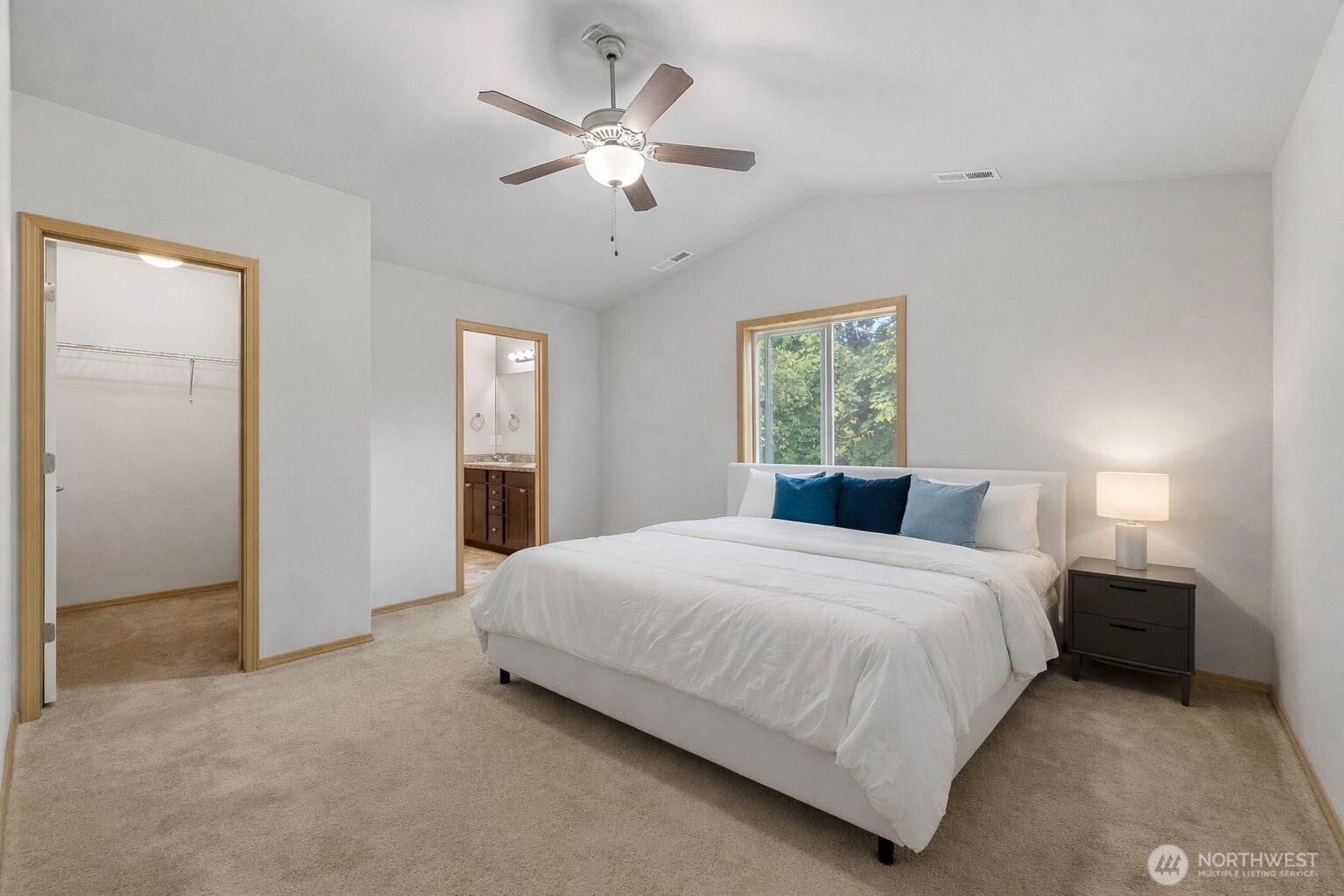 1537 East Gateway Heights Loop Sedro-Woolley, WA 98284 - Photo 15 of 23 a bedroom with a large bed and a chandelier