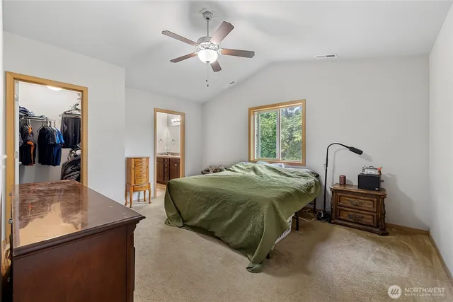 a spacious bedroom with a bed and a chandelier