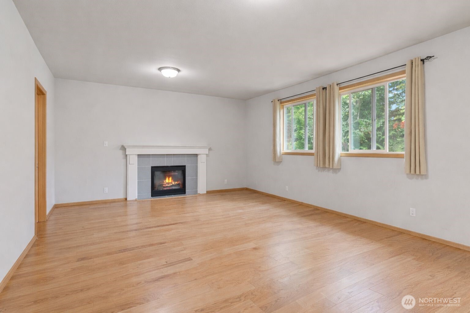 1537 East Gateway Heights Loop Sedro-Woolley, WA 98284 - Photo 6 of 23 a view of an empty room with a window and fireplace