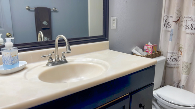 1797 Sunset Road Enoch, UT 84721 - Photo 44 of 80 Vanity with integrated sink, brushed nickel faucet, and dark wood cabinetry