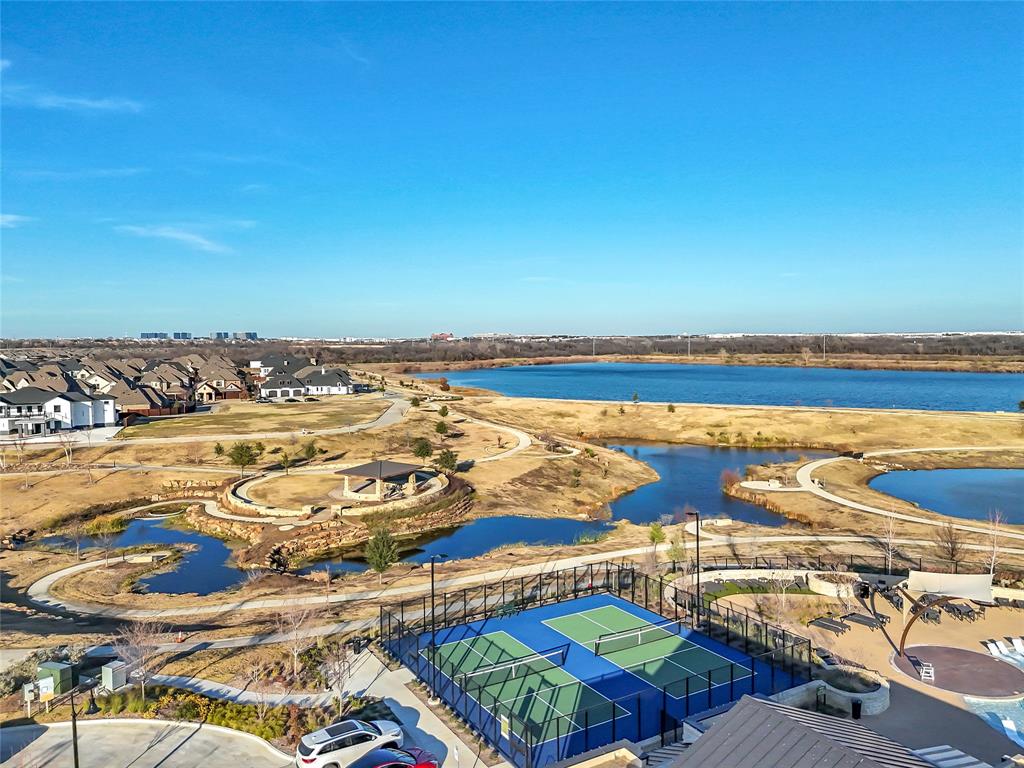 1011 Prairie Ridge Lane Arlington, TX 76005 - Photo 4 of 32 Community with multiple paddleball courts and a large blue water feature, surrounded by paved walking paths, open-air gazebos, and residential properties