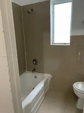 a bathroom with a bathtub and window