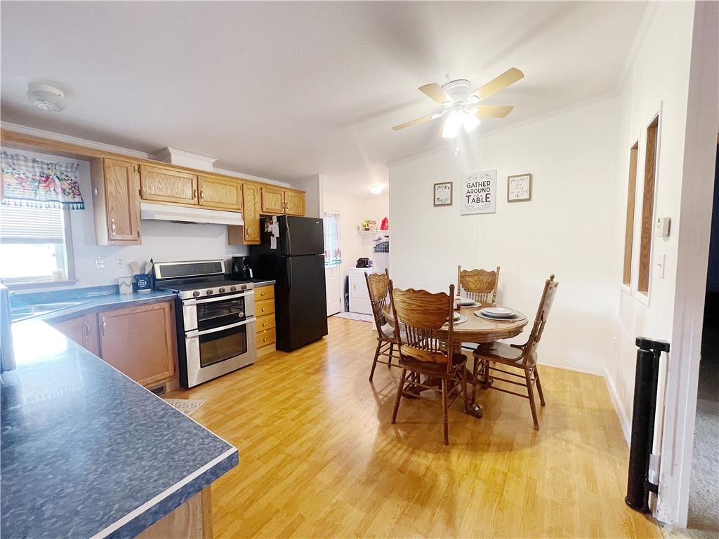 121 Mountain View Drive Berlin, PA 15530 - Photo 12 of 36 a dining room with stainless steel appliances kitchen island granite countertop a table chairs and a refrigerator