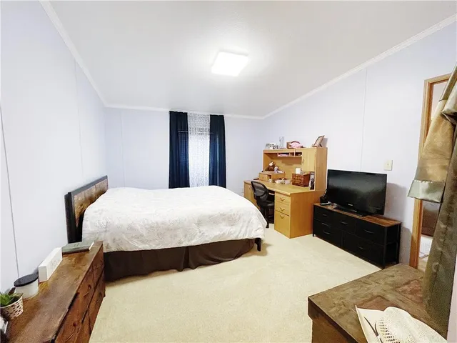 a bedroom with bed and tv