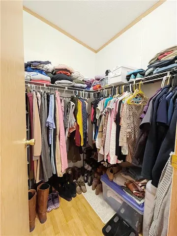a view of walk in closet with clothes