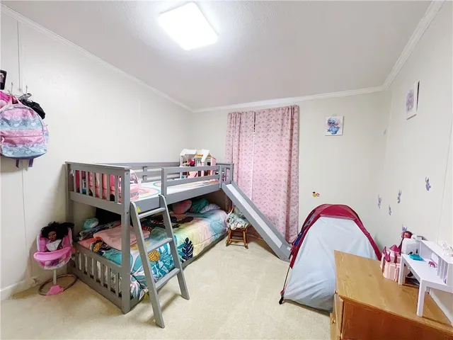 a bedroom with furniture and a baby crib