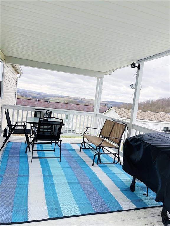 121 Mountain View Drive Berlin, PA 15530 - Photo 31 of 36 a living room with furniture a rug potted plant and a large window