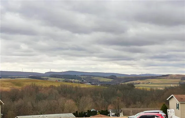 a view of a house with snow on the tree
