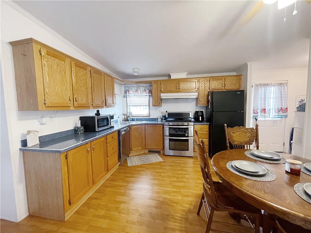 121 Mountain View Drive Berlin, PA 15530 - Photo 10 of 36 a kitchen with stainless steel appliances granite countertop a stove top oven a sink dishwasher and cabinets with wooden floor