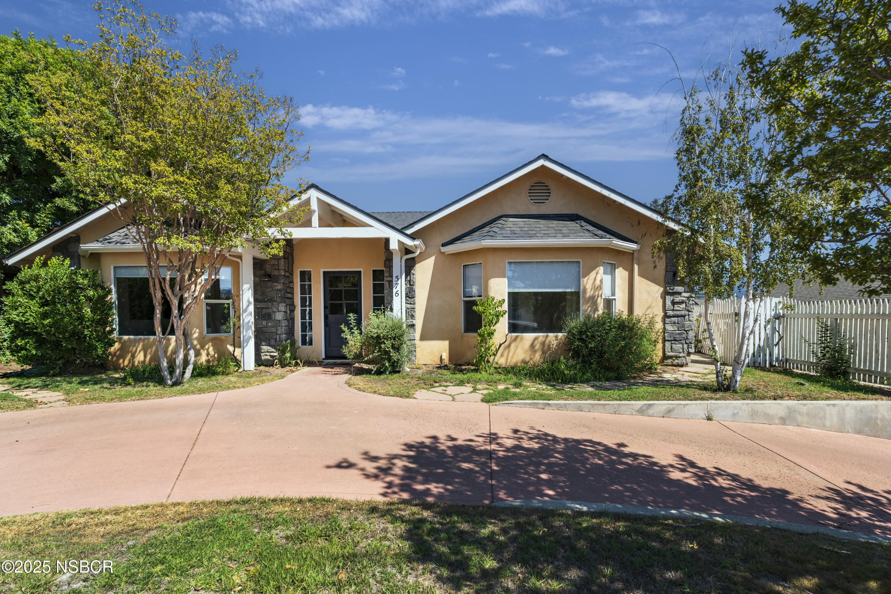 576 Pine Street, Unit A Solvang, CA 93463 - Photo 1 of 19 a front view of a house with a yard