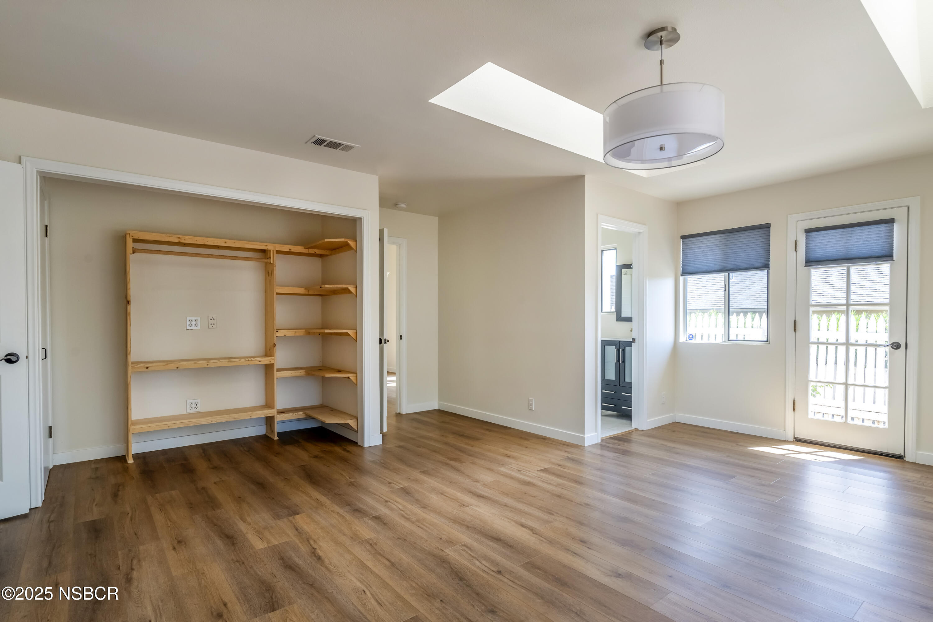 576 Pine Street, Unit A Solvang, CA 93463 - Photo 13 of 19 an empty room with wooden floor closet and windows