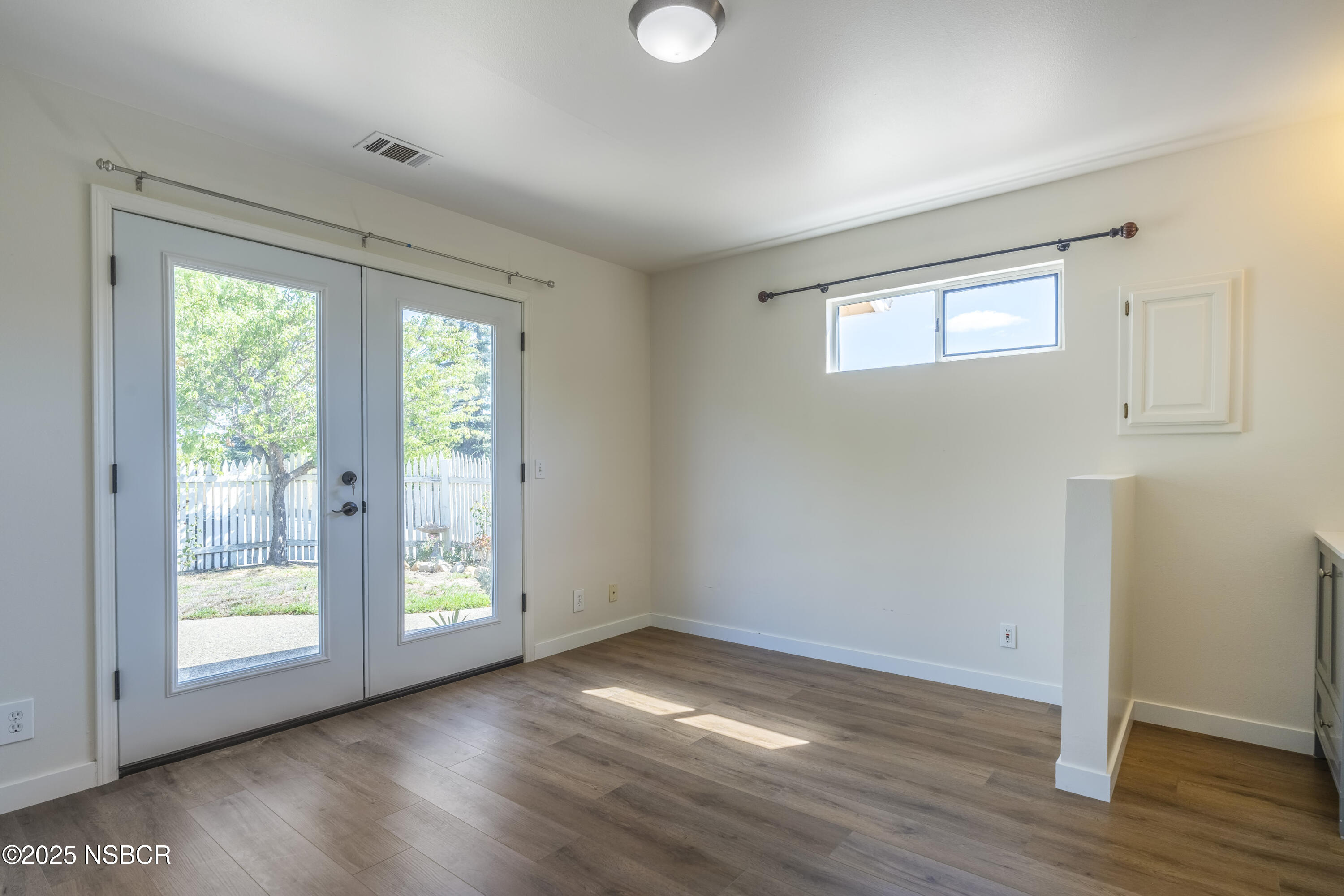576 Pine Street, Unit A Solvang, CA 93463 - Photo 14 of 19 a view of an empty room with wooden floor and a window