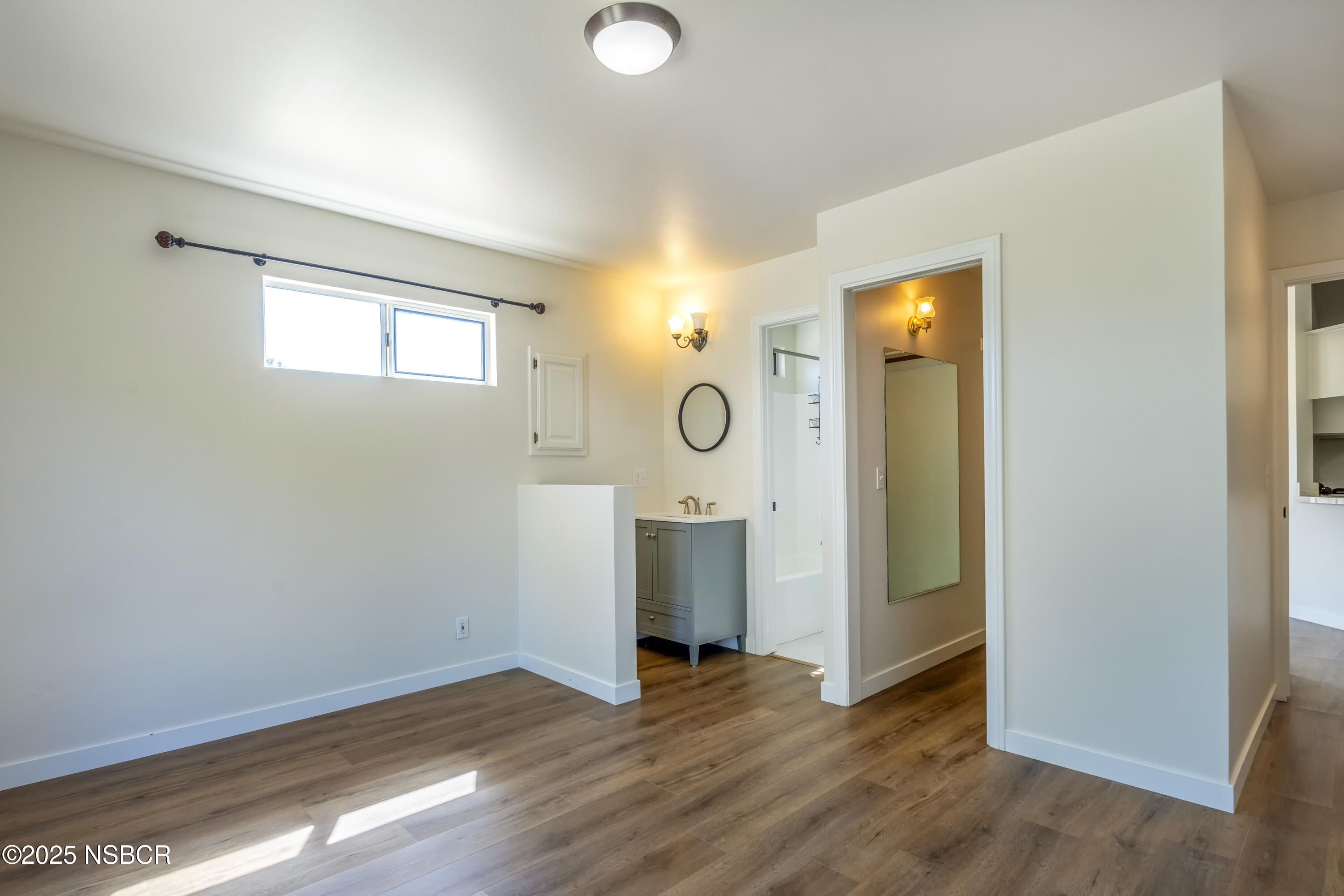 576 Pine Street, Unit A Solvang, CA 93463 - Photo 15 of 19 an empty room with wooden floor and windows