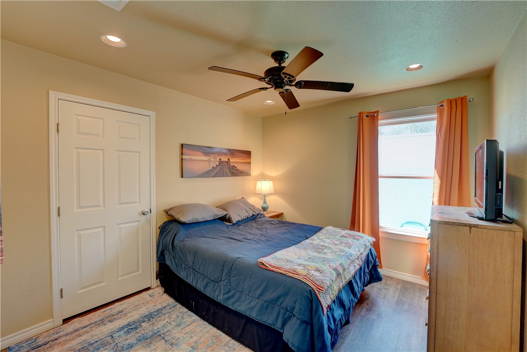 2102 Prairie Road Rockport, TX 78382 - Photo 13 of 26 a bedroom with a bed and a flat screen tv
