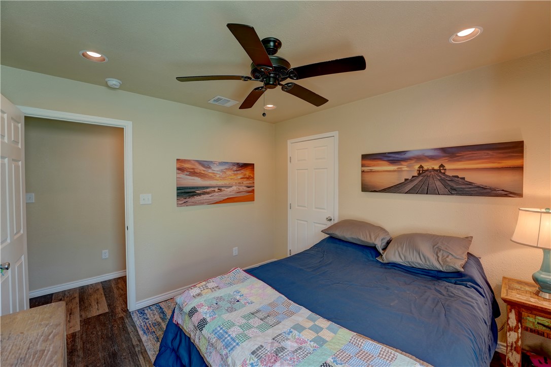 2102 Prairie Road Rockport, TX 78382 - Photo 14 of 26 a bedroom with a bed and a chandelier